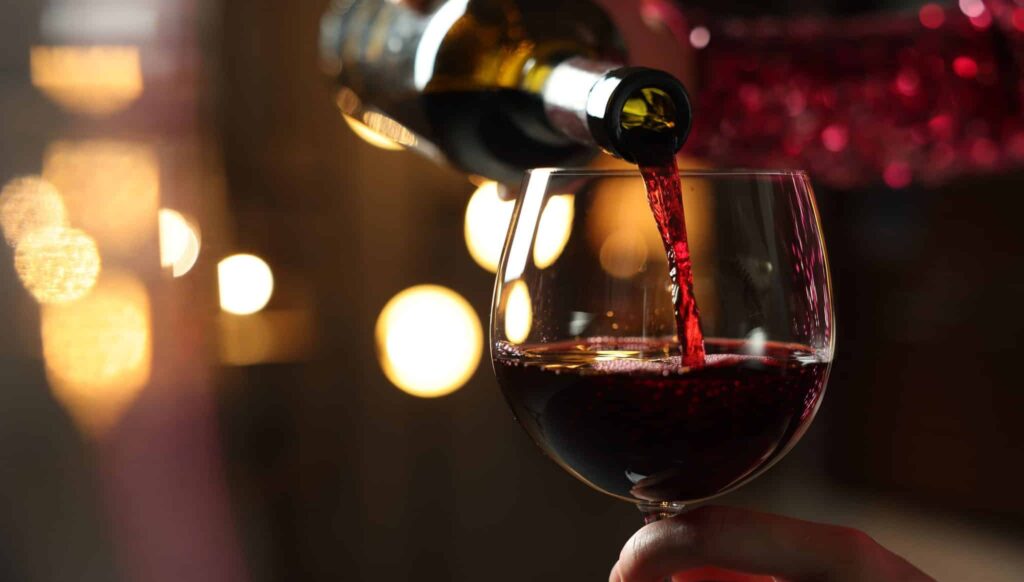 Glass of Pomerol red wine showing deep garnet colour