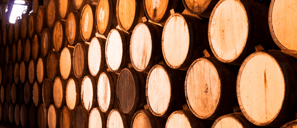 Rows of oak barrels ageing Cognac eaux-de-vie in a stone cellar