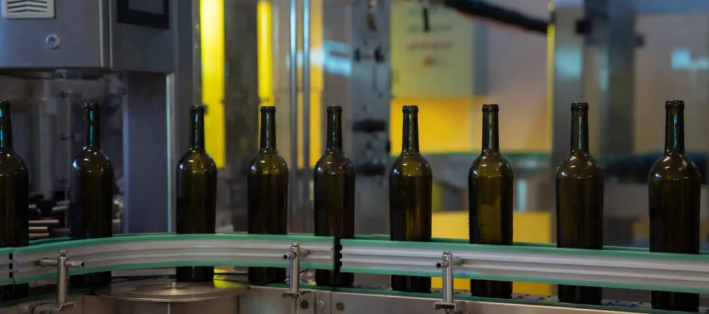 Bottles of Bordeaux wine resting in a château cellar